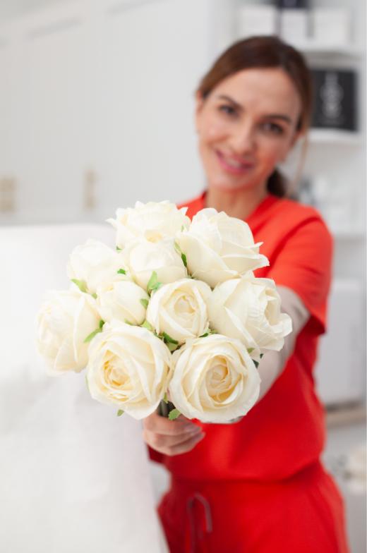 Aesthetics provider standing beside M22 laser device at med spa clinic in Southlake Texas