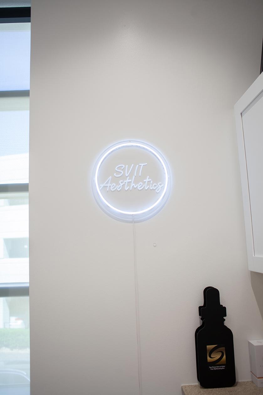 Interior view of SVIT Aesthetics in Southlake featuring illuminated brand signage