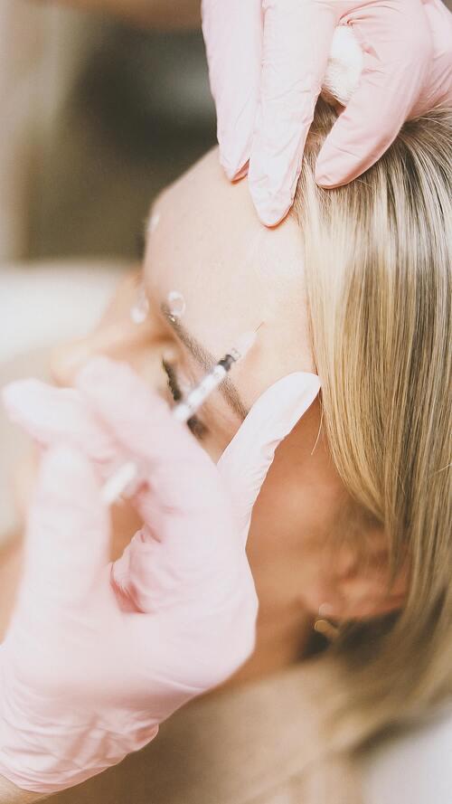 aesthetician administering a precision based injectable treatment on a patient in Southlake texas
