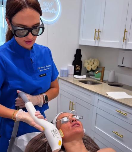 Patient receiving IPL photofacial treatment with the Lumenis Stellar M22 device while wearing protective eye shields.
