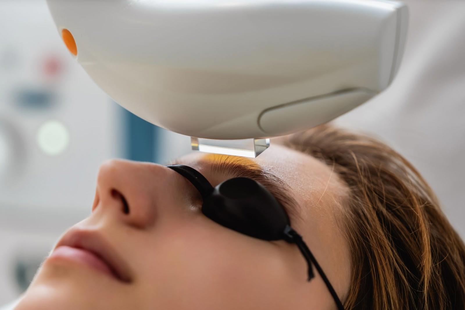 Close-up of a patient wearing protective eye shields during IPL treatment for dry eye comfort at an eye clinic.