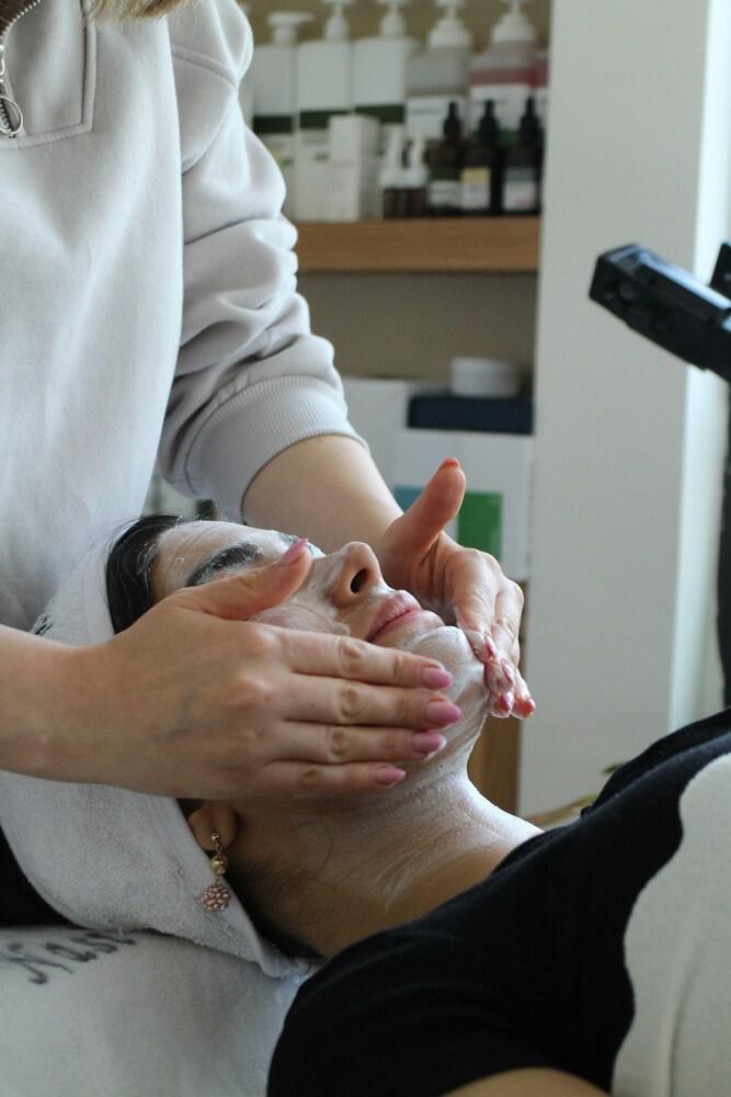 a woman getting a facial treatment